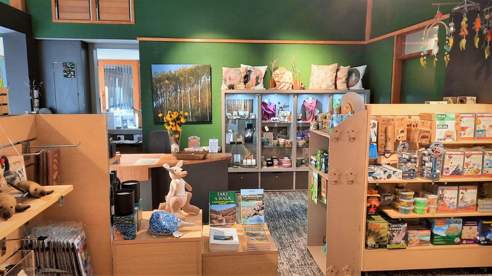 Botanic Garden gift shop counter and surrounding shelves with gift stock on them banner image