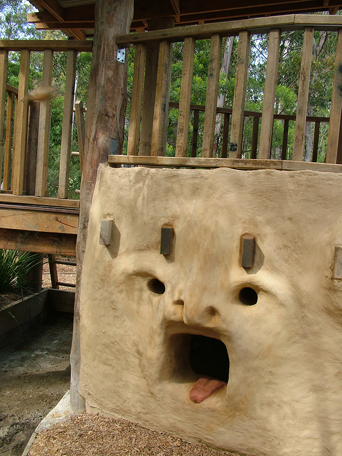 Mouth and eyes sculpted into the mud brick cubby