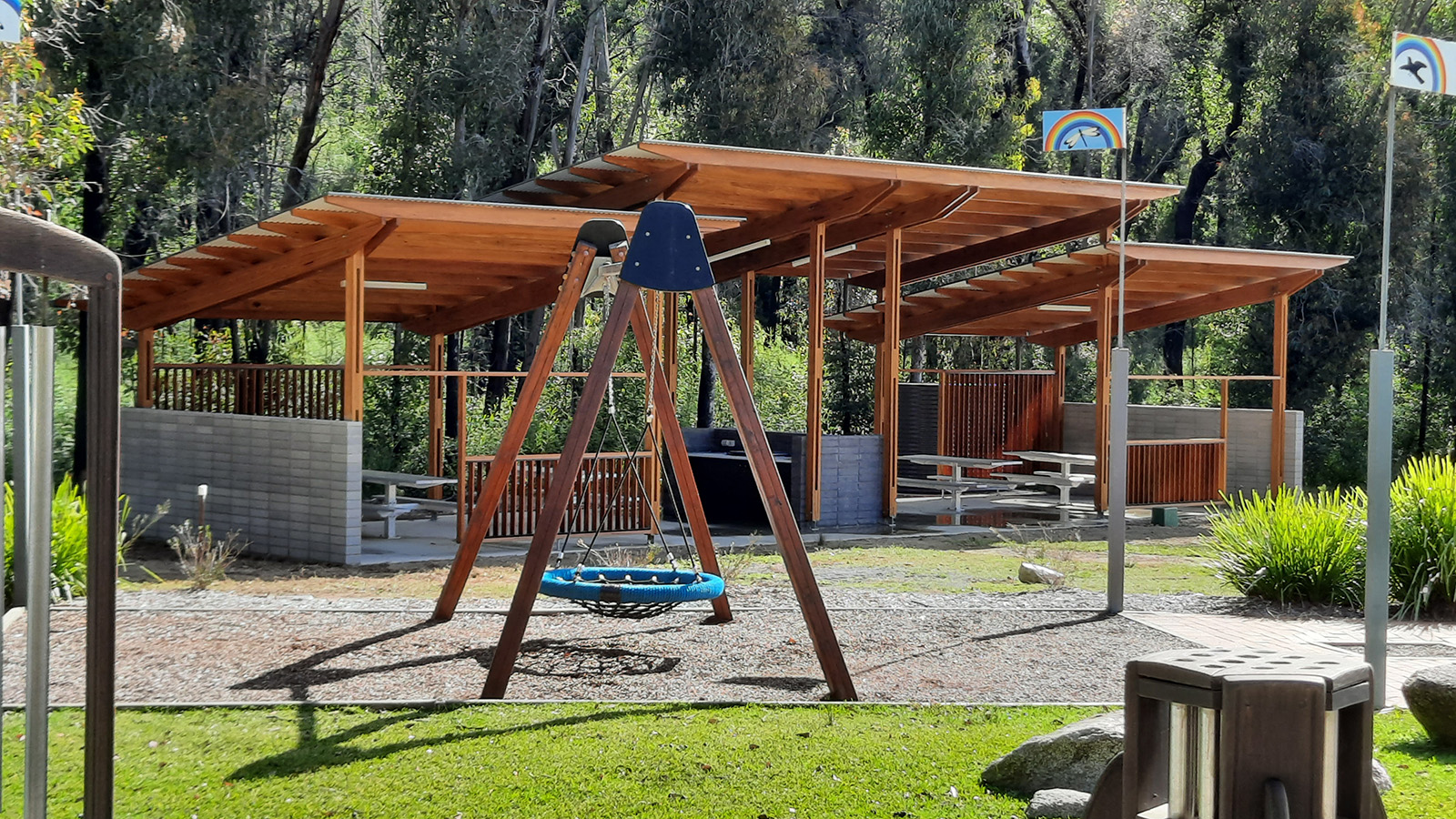 Image Swing play equipment and an outdoor barbecue shelter area